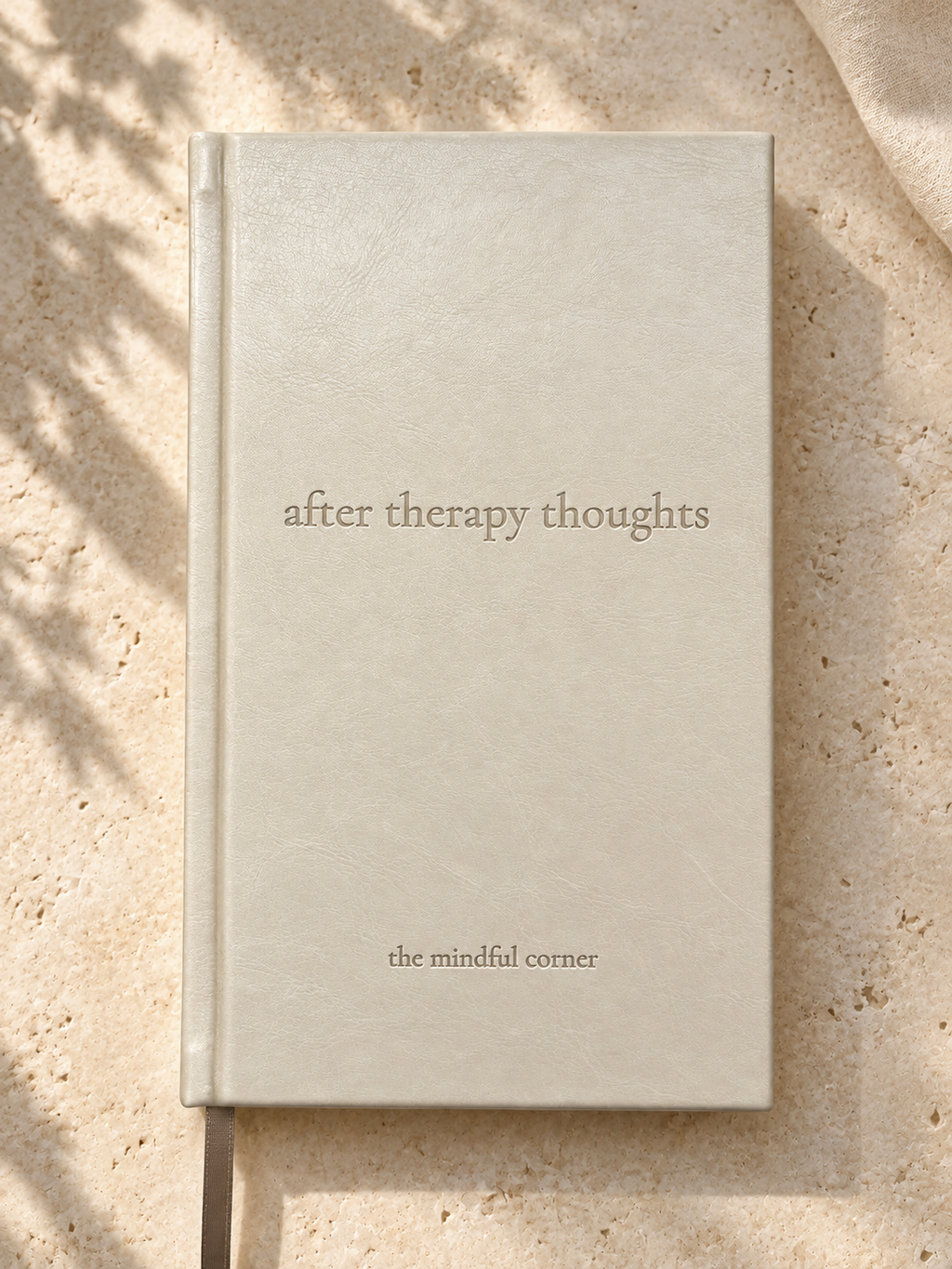 After Therapy Thoughts hardcover journal in cream bonded leather with a debossed title, shown from above